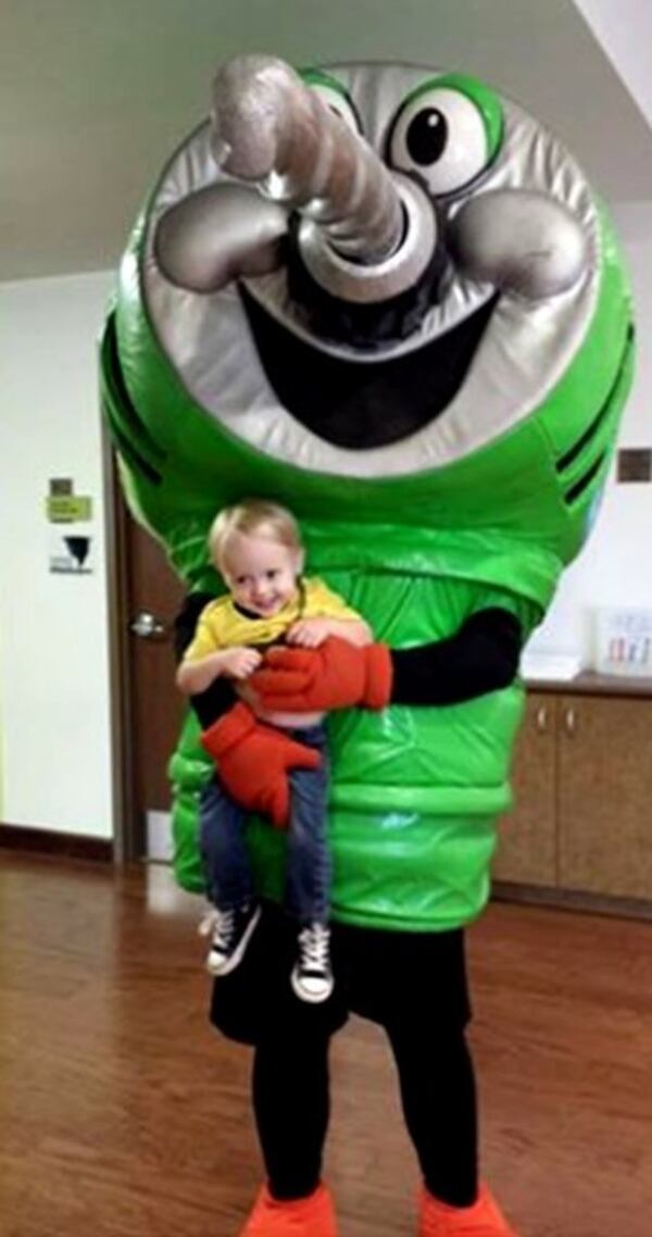 From 2014: Justin Ross Harris, costumed as a Home Depot power drill, holds his son, Cooper, in this family photo from 2014. This moment was remembered by one of Harris' coworkers, who said that Harris liked to show off Cooper to his coworkers. (Photo from Facebook)