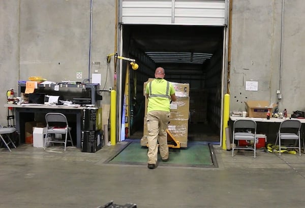 A worker loads voting machines onto the final truck delivering new Georgia election equipment across the state on Friday, Feb. 14, 2020. All in-person voters will use the touchscreen-and-printer voting system starting with next month’s presidential primary. Photo: Georgia secretary of state’s office.