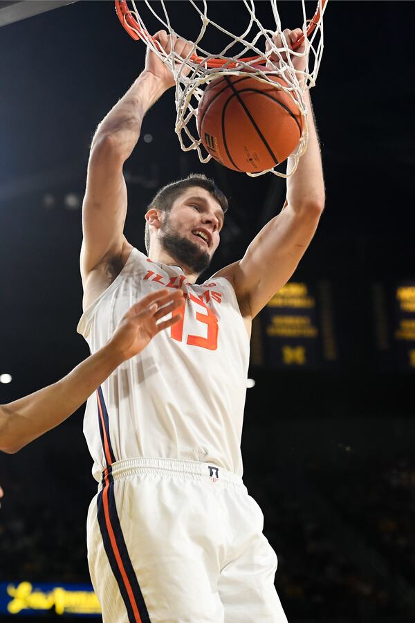 Illinois center Tomislav Ivisic dunks during the first half of an NCAA college basketball game against Michigan, Sunday, March 2, 2025, in Ann Arbor, Mich. (AP Photo/Jose Juarez)