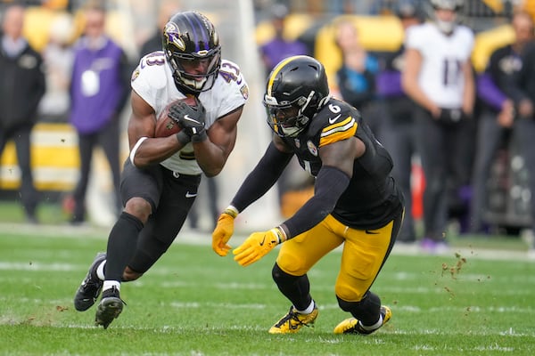 Baltimore Ravens running back Justice Hill (43) runs with the ball as Pittsburgh Steelers linebacker Patrick Queen (6) moves in for the tackle during the second half of an NFL football game, Sunday, Nov. 17, 2024, in Pittsburgh. (AP Photo/Gene J. Puskar)