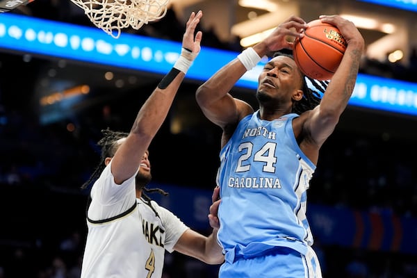 North Carolina forward Jae'Lyn Withers pull a rebound away from Wake Forest forward Efton Reid III during the second half of an NCAA college basketball game in the quarterfinals of the Atlantic Coast Conference tournament, Thursday, March 13, 2025, in Charlotte, N.C. (AP Photo/Chris Carlson)