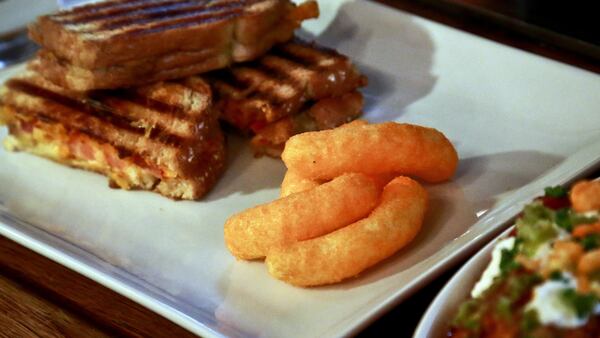 A grill cheese made with Cheetos is shown during a press preview for a three-day pop-up restaurant featuring an all-Cheetos menu, Tuesday Aug. 15, 2017, in New York. Celebrity chef Anne Burrell has been given the unenviable task of creating an entire menu for a pop-up restaurant based on Cheetos. (AP Photo/Bebeto Matthews)