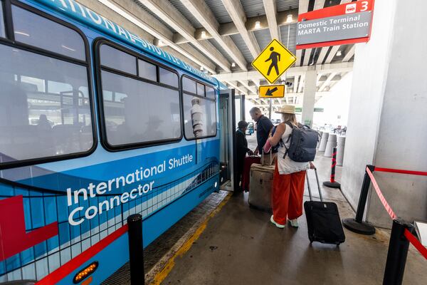 Passengers board the terminal-to-terminal shuttle at the international terminal Tuesday, Sept. 29, 2023.  (Steve Schaefer/steve.schaefer@ajc.com)