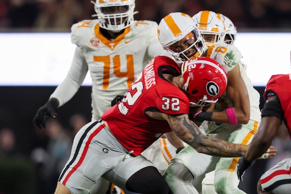 Georgia linebacker Chaz Chambliss (32) tackles Tennessee quarterback Nico Iamaleava (8) during the first quarter at Sanford Stadium, Saturday, November 16, 2024, in Athens, Ga. Georgia won 31-17. (Jason Getz / AJC)
