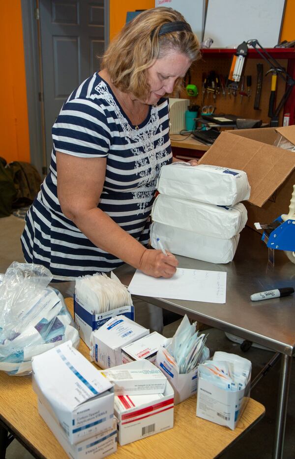 Maggie Shane prepares medical supplies for shipping to help the poor in Nicaragua at the Amigos for Christ warehouse and office in Buford. (Phil Skinner/For the AJC)