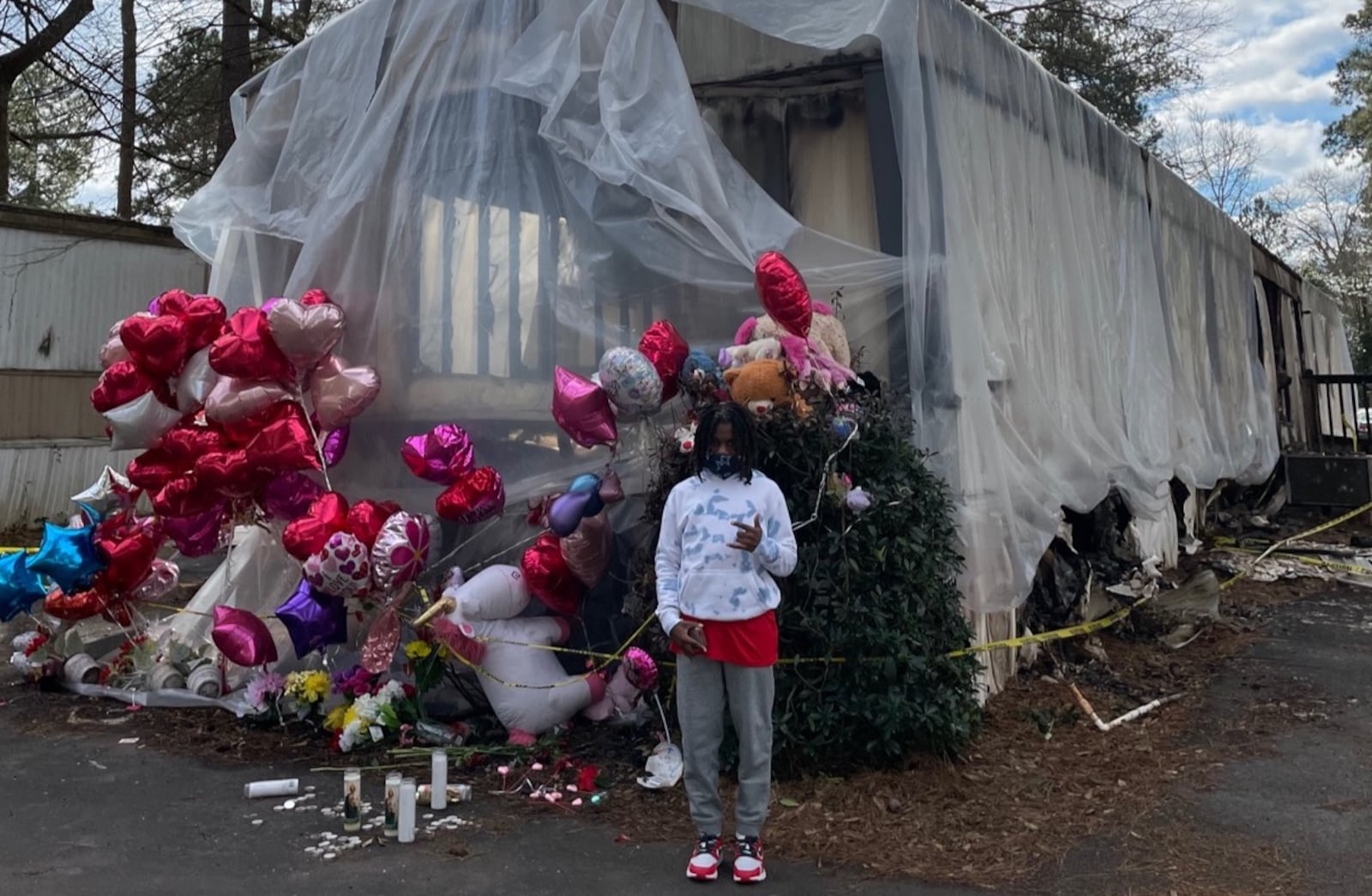 Taeden Johnson of Athens poses in front of the remains of the home he shared with his mother, grandmother and 9-year-old sister. He was the only survivor from a fire that destroyed the mobile home in Athens on Jan. 27. (Photo by Zac Hendrix)