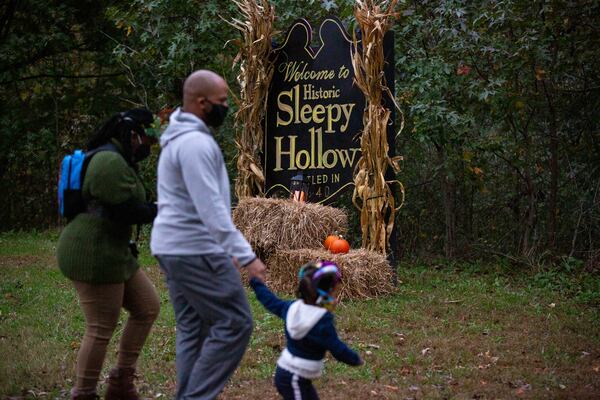 Audience members enter the Sleepy Hollow trail at Cambridge High School in Milton, Georgia, on Saturday, October 31, 2020. The Cambridge High School Theatre program performed The Occurrence at Sleepy Hollow outside along the school’s trails; audience members were guided through different stages of the short story by Washington Irving. (Rebecca Wright for the Atlanta Journal-Constitution)