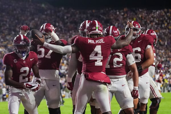 Alabama quarterback Jalen Milroe (4) celebrates a touchdown carry in the second half an NCAA college football game against LSU in Baton Rouge, La., Saturday, Nov. 9, 2024. (AP Photo/Gerald Herbert)