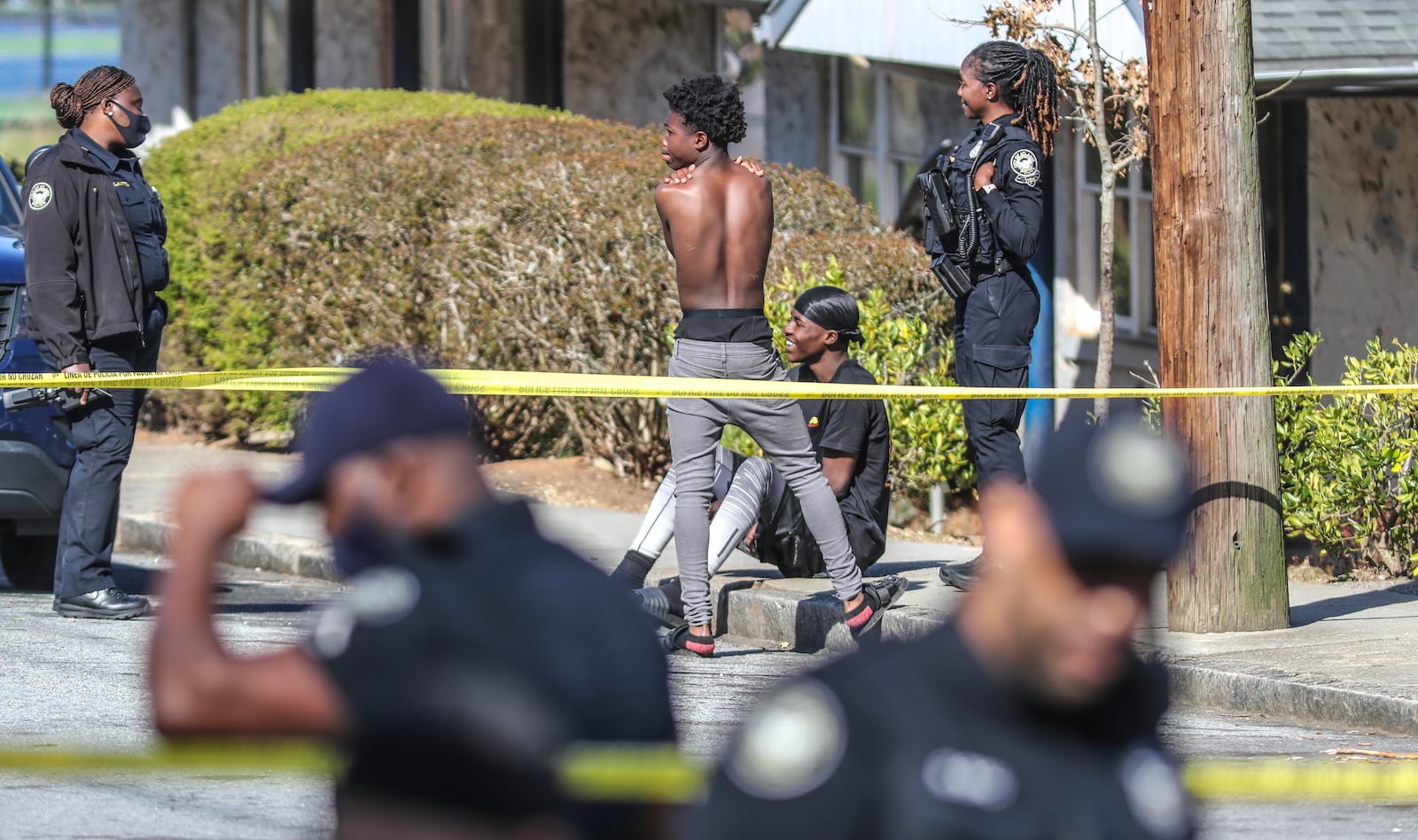 Atlanta police talk to two young men in the wake of the shooting of a 15-year-old boy at Oakland City West End Apartments in March. Police say that the crime that has become astonishingly routine in many complexes often is committed by people who do not live at the properties. (John Spink / John.Spink@ajc.com)