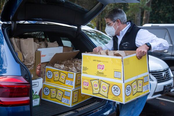 American Legion Post 140 Buckhead member Jonathan Reeder loads boxes of lunch bags into a vehicle for USO Operation: Holiday Block Leave.  PHIL SKINNER FOR THE ATLANTA JOURNAL-CONSTITUTION.