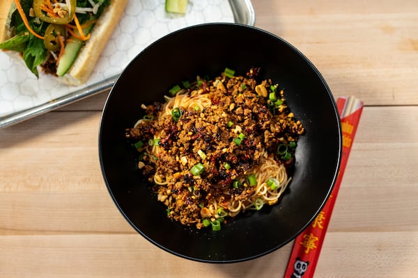 Sloppy Dan Dan Noodle bowl with grass-fed beef, Sichuan oil, pasta, green onion, and peanuts. Photo credit- Mia Yakel.