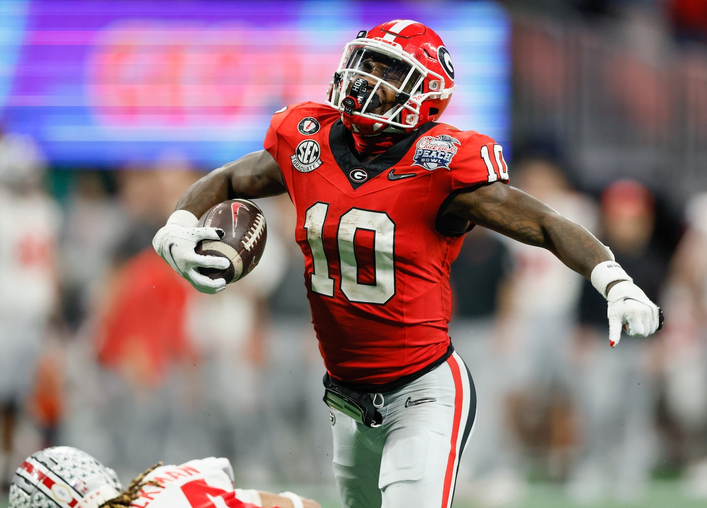 Georgia Bulldogs wide receiver Kearis Jackson (10) celebrates after completing a 35 yard pass for a first down to set up Georgia's go ahead score during the fourth quarter of the College Football Playoff Semifinal between the Georgia Bulldogs and the Ohio State Buckeyes at the Chick-fil-A Peach Bowl In Atlanta on Saturday, Dec. 31, 2022.  Georgia won, 42-41. (Jason Getz / Jason.Getz@ajc.com)