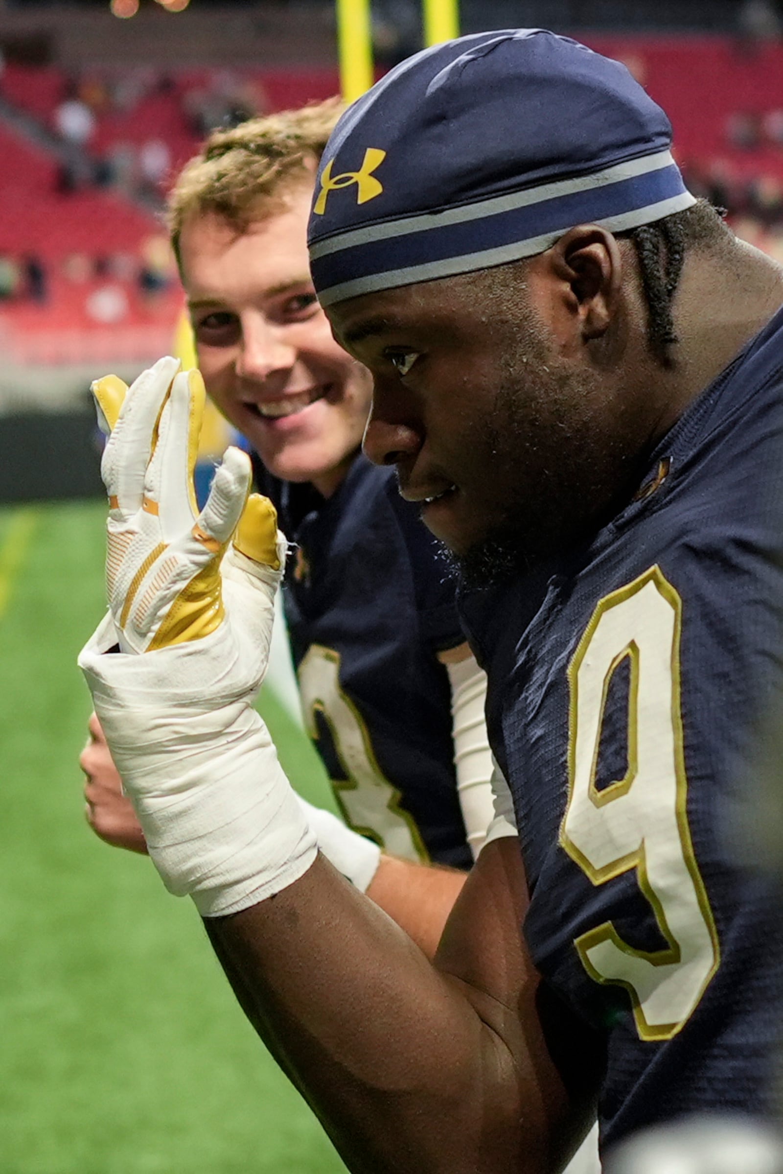 Notre Dame quarterback Riley Leonard, left, and Notre Dame tight end Eli Raridon walk off the field after an NCAA college football game against Georgia Tech, Saturday, Oct. 19, 2024, in Atlanta. (AP Photo/Mike Stewart)