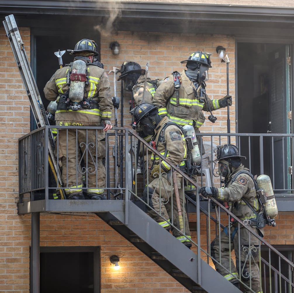 July 7, 2022 Atlanta: Atlanta firefighters had a hot morning battling an apartment blaze in the 2200 block of Campbellton Road in Atlanta on Thursday, July 7, 2022. The call came in at 9 am for the Adams House Apartments where units arrived to heavy smoke conditions according to Atlanta Fire Rescue Captain Taurus Durrah. Flames erupted from the bottom floor to the top floor and then the attic Durrah said. Crews initially had to bring in tank water to get water on the fire because of the 800 foot distance to the hydrant on Campbellton Road. Four units were damaged and 8-families displaced. No one was injured and the fire is under investigation. Durrah said more units are being sent to fire scene to shorten the rotation of fire crews due to the heat. Firefighters are told to hydrate  and stay cool a full shift before coming to work to combat the heat. (John Spink / John.Spink@ajc.com)


