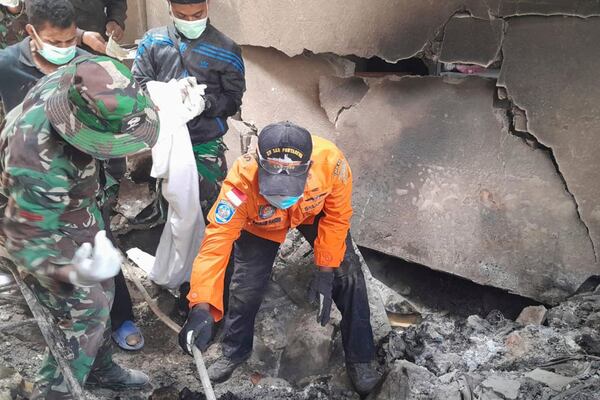 In this photo released by the Indonesian National Search and Rescue Agency (BASARNAS), rescuers search for victims of the eruption of Mount Lewotobi Laki-Laki in East Flores, Indonesia on Monday, Nov. 4, 2024. (BASARNAS via AP)