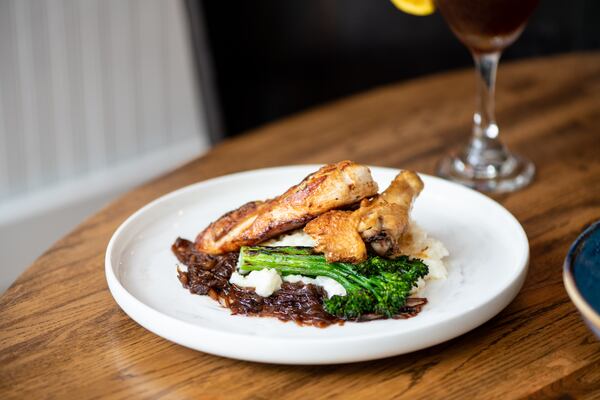 A-street "Flat Iron" Chicken Breast with Springer Mountain chicken, Gruyere risotto, French onion confit, and broccolini. (Mia Yakel for The Atlanta Journal-Constitution)