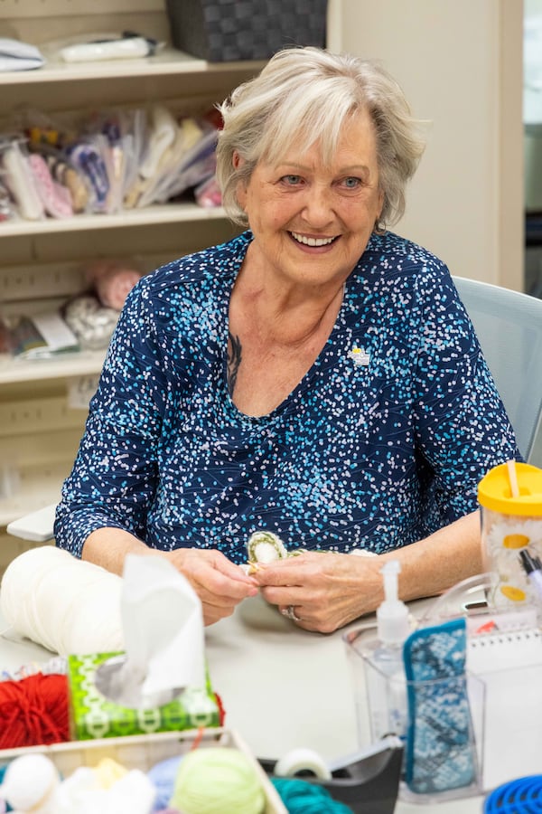 Kathy DeJoseph chats with her fellow Happy Caps volunteers as they knit caps for patients at the Wellstar West Cobb Medical Center in Marietta, Georgia. (Phil Skinner for the AJC) 