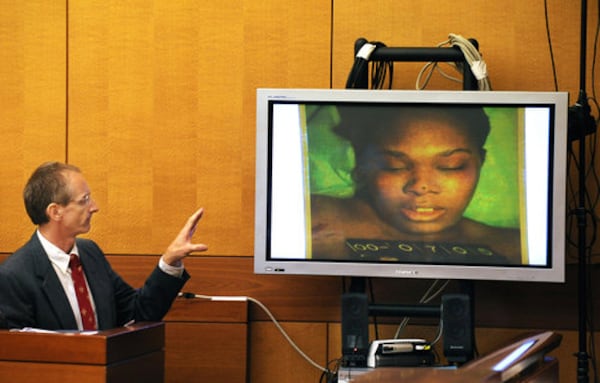 Dr. Michael Henniger of the Fulton County Medical Examiners office identifies the picture on the monitor as Sparkle Rai during the 2008 murder trial of Chiman Rai.