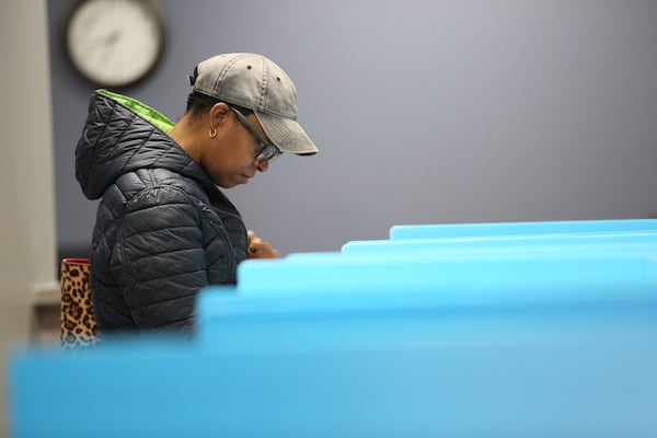 Vallerie Roy (44) of Dekalb County cast her ballot during the first day of early voting at Voter Registration and Elections Office in Atlanta on Monday, March 2, 2020.