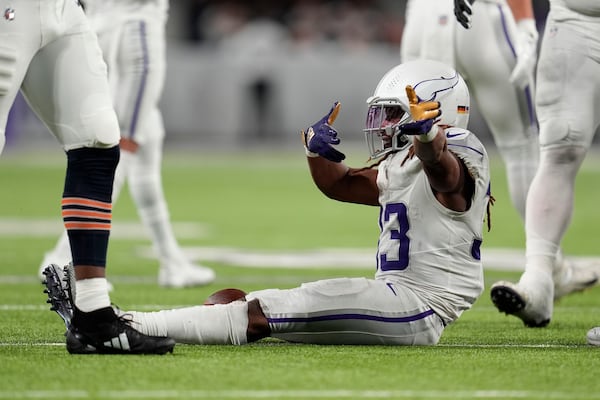 Minnesota Vikings running back Aaron Jones (33) reacts after running for a first down during the second half of an NFL football game against the Chicago Bears, Monday, Dec. 16, 2024, in Minneapolis. (AP Photo/Abbie Parr)