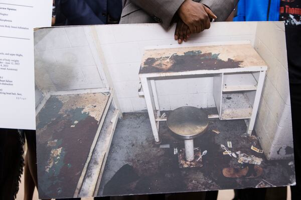 Attorney Michael Harper holds a photo of Lashawn Thompson's cell in the Fulton County Jail at a press conference addressing the results of an independent autopsy determining the cause of death for Thompson on Monday, May 22, 2023, at the State Capitol in Atlanta. Thompson’s family and legal team released the results of an autopsy that determined that his death in the psychiatric wing of the Fulton County Jail resulted from neglect. CHRISTINA MATACOTTA FOR THE ATLANTA JOURNAL-CONSTITUTION.