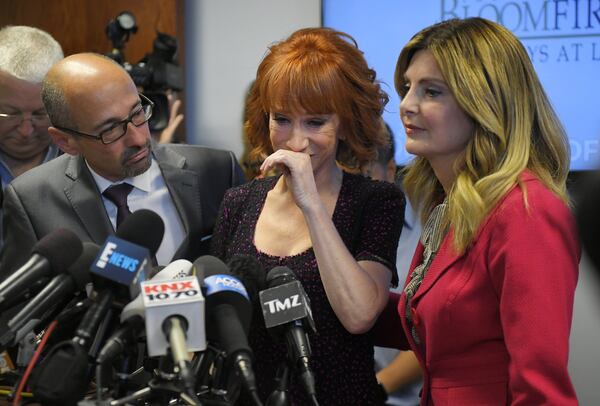 Comedian Kathy Griffin (center) sobs as she speaks along with her attorneys Dmitry Gorin (left) and Lisa Bloom on June 2, 2017, in Los Angeles. They were discussing the backlash after Griffin released a photo and video of her displaying a likeness of President Donald Trump’s severed head, for which Griffin apologized. One consequence was that CNN fired her from its annual New Year’s Eve show. MARK J. TERRILL / ASSOCIATED PRESS