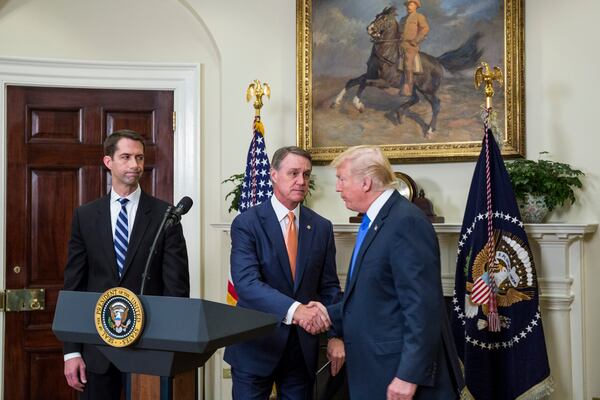 President Donald Trump, right, used a White House event to help boost the prospects for a bill on legal immigration that U.S. Sens. Tom Cotton and David Perdue had sponsored. (Zach Gibson/Pool/Sipa USA/TNS)