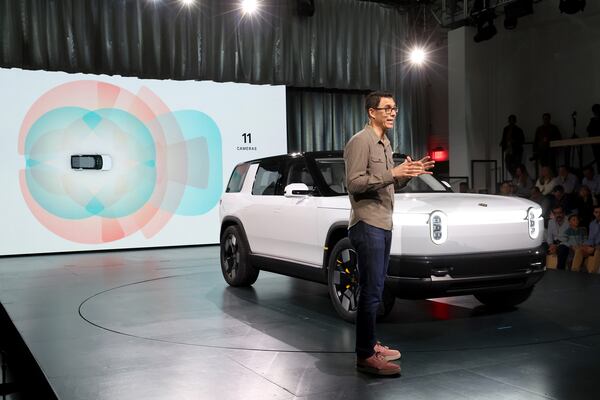 Founder and CEO of Rivian RJ Scaringe speaks onstage during the Rivian Reveals All-Electric R2 Midsize SUV event at Rivian South Coast Theater on March 7, 2024, in Laguna Beach, California. (Phillip Faraone/Getty Images for Rivian/TNS)