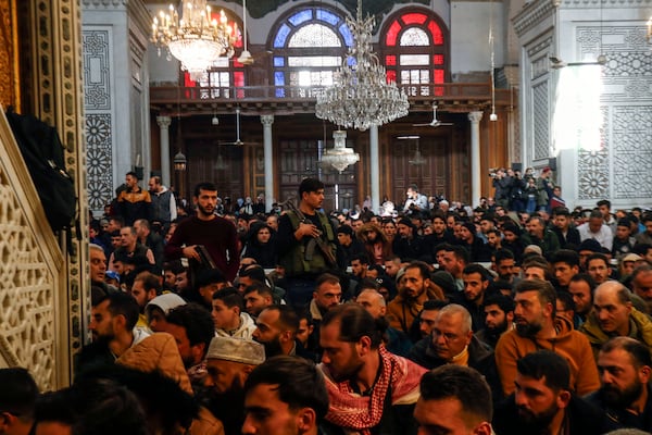 Syrians perform Friday prayers inside the 7th century Umayyad Mosque in Damascus, Syria, Friday, Dec. 13, 2024. (AP Photo/Omar Sanadiki)