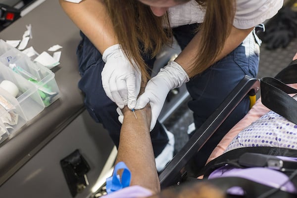 Wilkes County EMS paramedic Rebekah Echols tries to start an IV for her 91-year-old patient, Mary Richards, in the back of the medical truck on a call in Washington, Thursday, October 3, 2019. The patient, who suffers from dementia, had fallen and was relocated to her bed by Wilkes County Firefighters before Wilkes County paramedics arrived. The patient was complaining about pain on her side and her son elected for her to be transported to Wills Memorial Hospital. (Alyssa Pointer/Atlanta Journal Constitution)