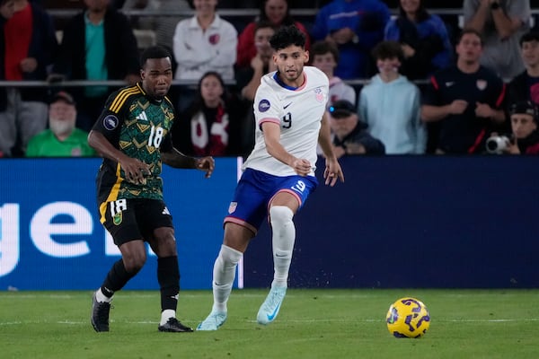 United States' Ricardo Pepi (9) and Jamaica's Tyreek Magee (18) chase after a loose ball during the first half in a CONCACAF Nations League quarterfinal second leg soccer match Monday, Nov. 18, 2024, in St. Louis. (AP Photo/Jeff Roberson)