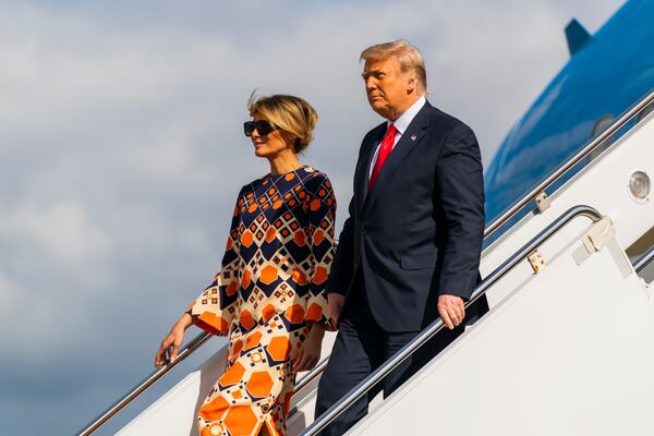 FILE - Former President Donald Trump, right, and Melania Trump disembark from their final flight on Air Force One at Palm Beach International Airport in West Palm Beach, Fla., Jan. 20, 2021. (AP Photo/Manuel Balce Ceneta, File)