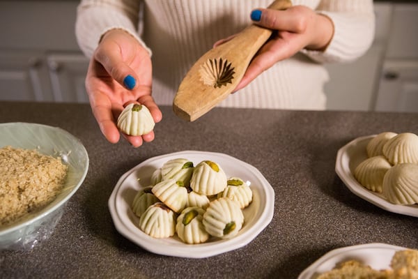 When Syrian refugees Ruwaida and her family walked away from Damascus, they brought only what they could carry. One of the few keepsakes of home is this wooden cookie mold. Ruwaida also brought skills in the kitchen, making pistachio and date and sesame cookies with recipes that she learned from her mother. Photo: PHIL SKINNER