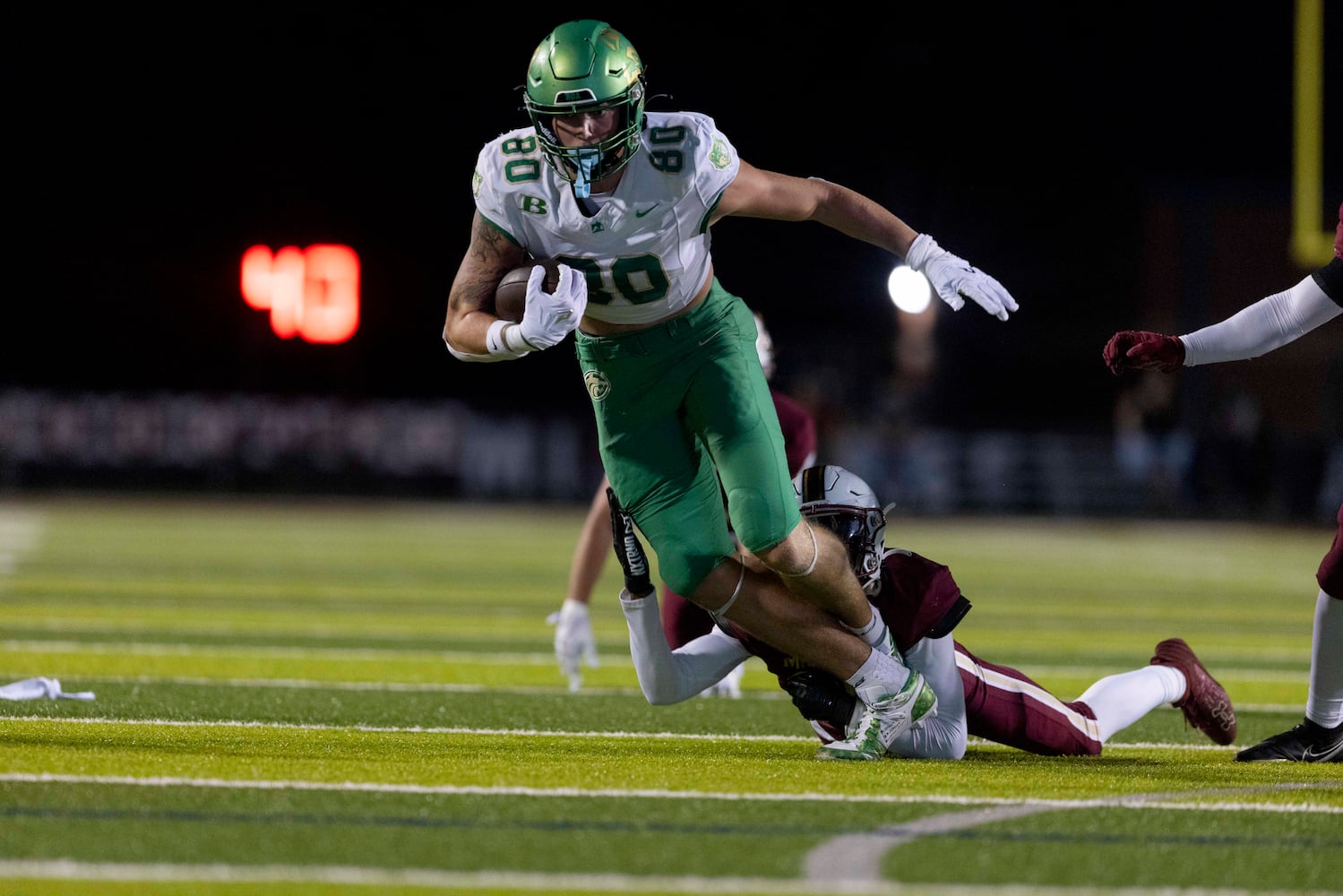 Buford’s Hayden Bradley (80) tries to pull away. (Photo/Jenn Finch, AJC)