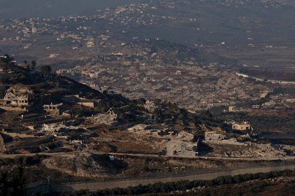 Destroyed buildings in the village of Kfar Kila, southern Lebanon, are seen from northern Israel, Tuesday, Dec. 3, 2024. (AP Photo/Maya Alleruzzo)