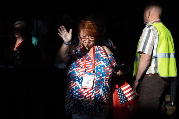 Cheri Whitney walks through a patch of light at the Georgia GOP convention in Columbus on Friday, June 9, 2023. (Arvin Temkar / arvin.temkar@ajc.com)