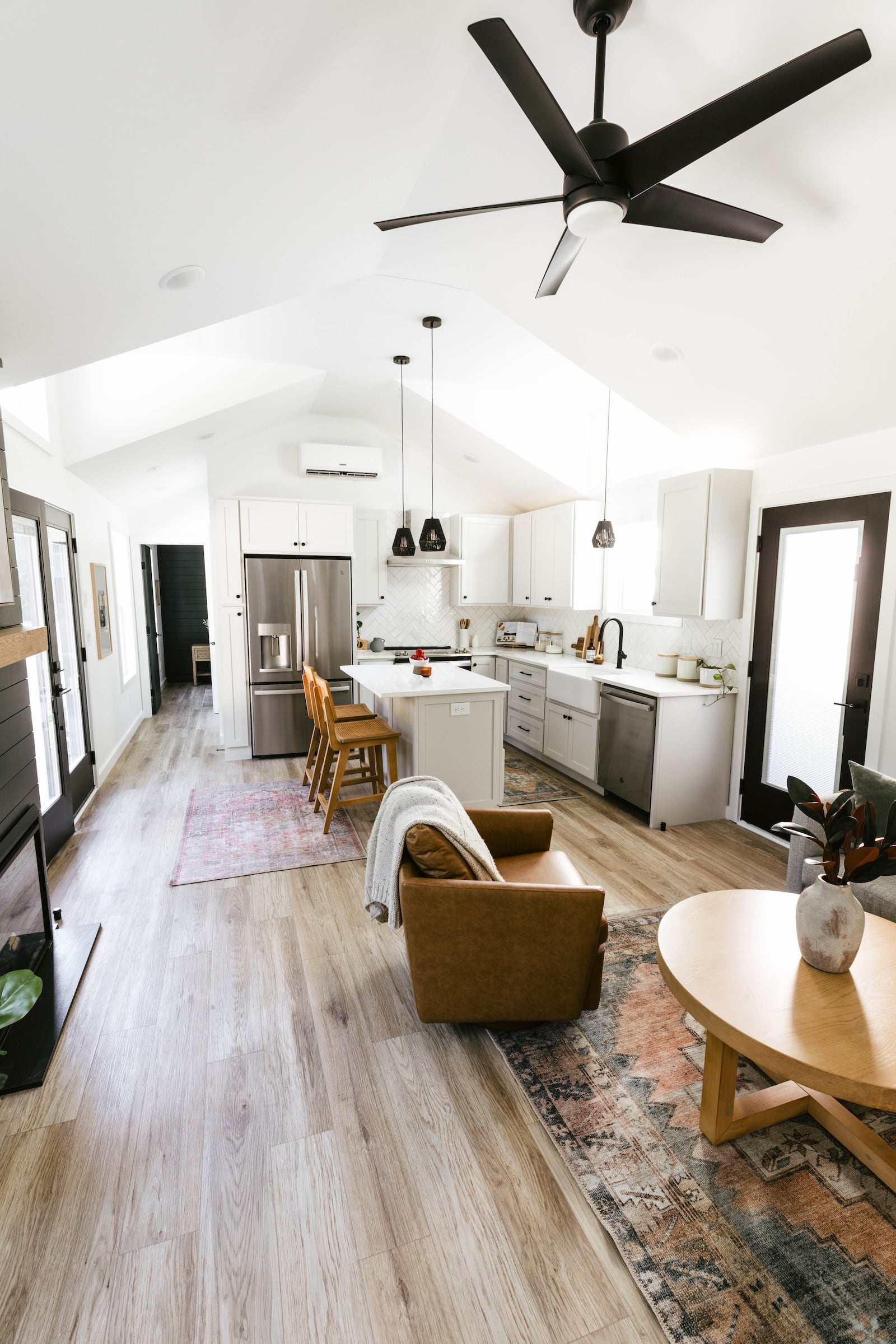 Throw rugs help differentiate between spaces in a home with a smaller footprint. Photo: Courtesy of Mustard Seed Tiny Homes