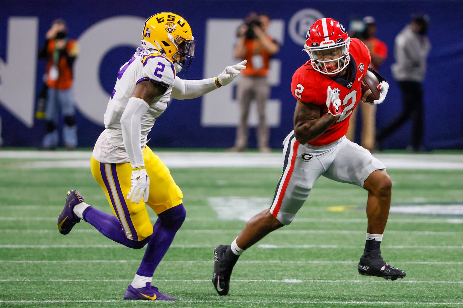 Georgia Bulldogs running back Kendall Milton, right, runs past LSU Tigers cornerback Mekhi Garner (2) for a first down during the first half of the SEC Championship Game at Mercedes-Benz Stadium in Atlanta on Saturday, Dec. 3, 2022. (Bob Andres / Bob Andres for the Atlanta Constitution)