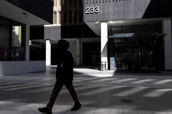 A person walks by the building that houses the Small Business Administration's Atlanta office in Atlanta. SBA will be closing it and ther regional in several other major cities, citing what Kelly Loeffler said was their “sanctuary city” policies protecting unauthorized immigrants. (Arvin Temkar / AJC)