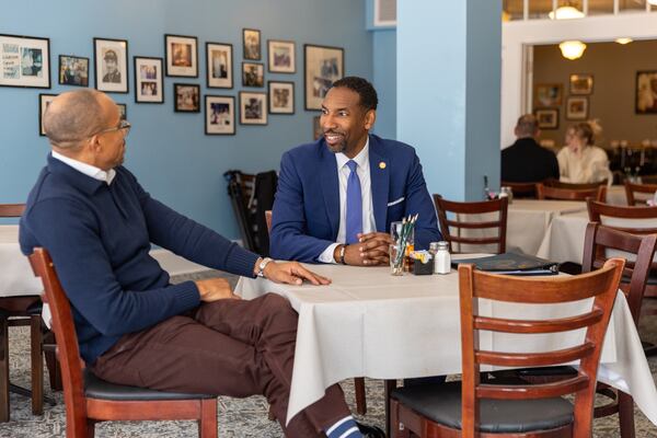 Mayor Andre Dickens (center) speaks to owner Harold Martin Jr. in a newly reopened dining room at Mary Mac’s restaurant in Atlanta on Thursday, February 20, 2025. The iconic restaurant temporarily closed in 2024 after heavy storm damage. (Arvin Temkar / AJC)