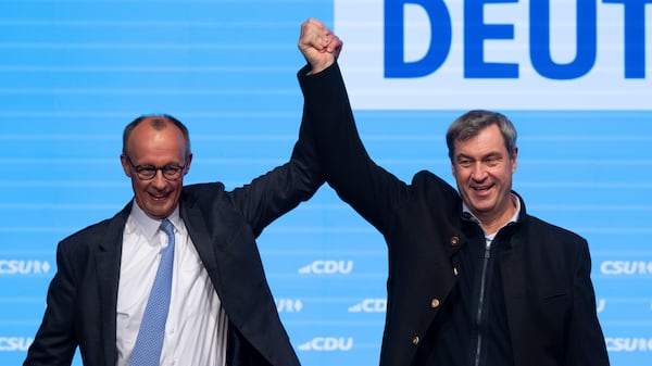 Friedrich Merz, left, leader of the Christian Democratic Union (CDU) and Markus Soeder, right, leader of the Christian Social Union (CSU), stand together during an elction campaing event in Munich, Germany, Saturday, Feb. 22, 2025. (Sven Hoppe/dpa via AP)