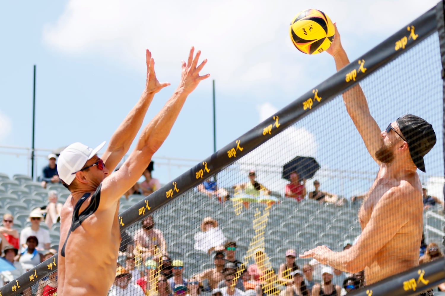 Theo Brunner spikes the ball against Paul Lotman during the AVP Gold Series Atlanta Open beach volleyball men's championship match Sunday at Atlantic Station. (Miguel Martinez / miguel.martinezjimenez@ajc.com)