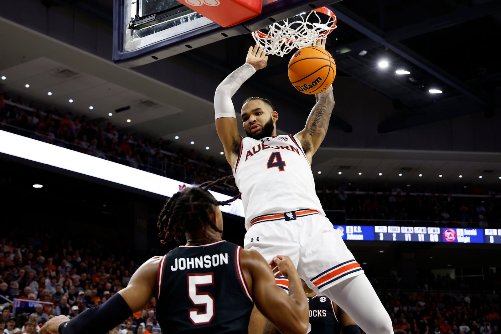 FILE - Auburn forward Johni Broome (4) slam dunks the ball over South Carolina guard Meechie Johnson (5) during the second half of an NCAA college basketball game Wednesday, Feb. 14, 2024, in Auburn, Ala. (AP Photo/Butch Dill, File)