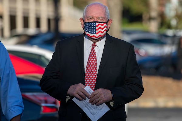 Under federal ethics rules, since his wife has a 1% stake in a family trust, that make U.S. Secretary of Agriculture and former Georgia governor Sonny Perdue a 1% stakeholder in the family's complex, multimillion-dollar business holdings, an Agriculture spokeswoman said. Perdue is seen here preparing to speak at a GOP briefing at Georgia Republican headquarters in Buckhead in November. (Alyssa Pointer / Alyssa.Pointer@ajc.com)