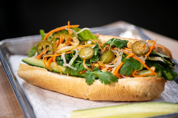 Dan Dan Banh Mi with Sichuan chili beef, pickled carrot, daikon, jalapeno, cucumber, cilantro, mint, Duke's Mayo, and toasted roll. Photo credit- Mia Yakel.