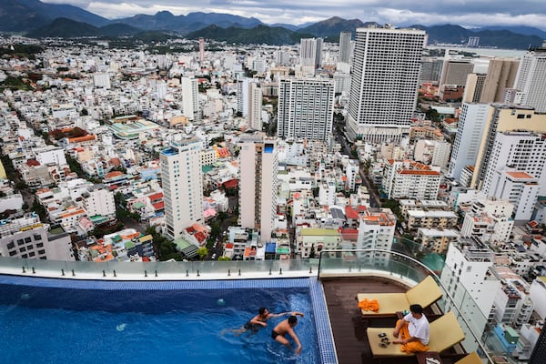 Tourists play in a pool at the Regalia Gold Hotel, in Nha Trang, Vietnam on Feb. 9, 2025. (AP Photo/Yannick Peterhans)