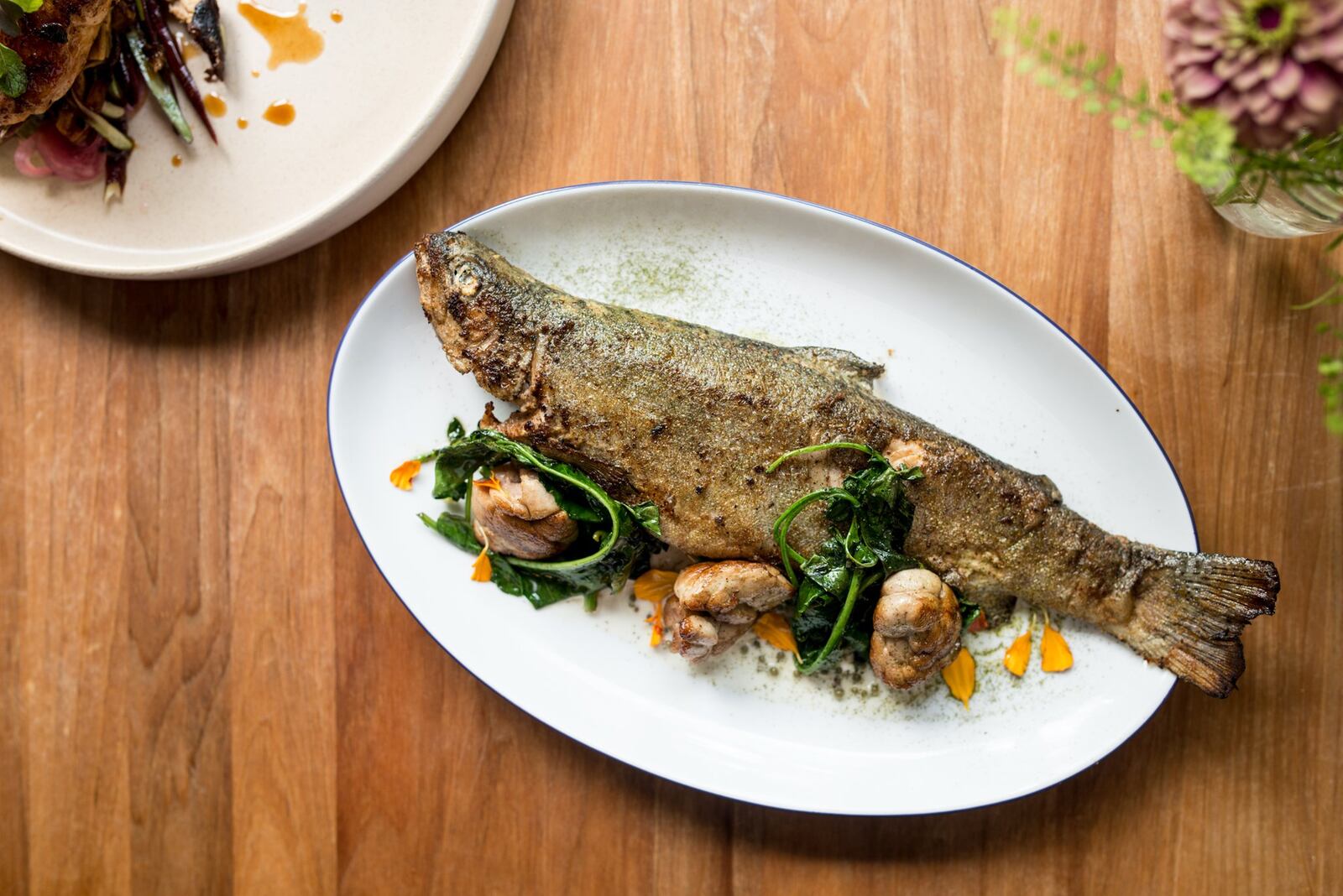 Whole Wood Roasted Bramlett Farm Trout with broccoli greens, green coriander cream, sweetbreads, and coriander powder. Photo credit- Mia Yakel.