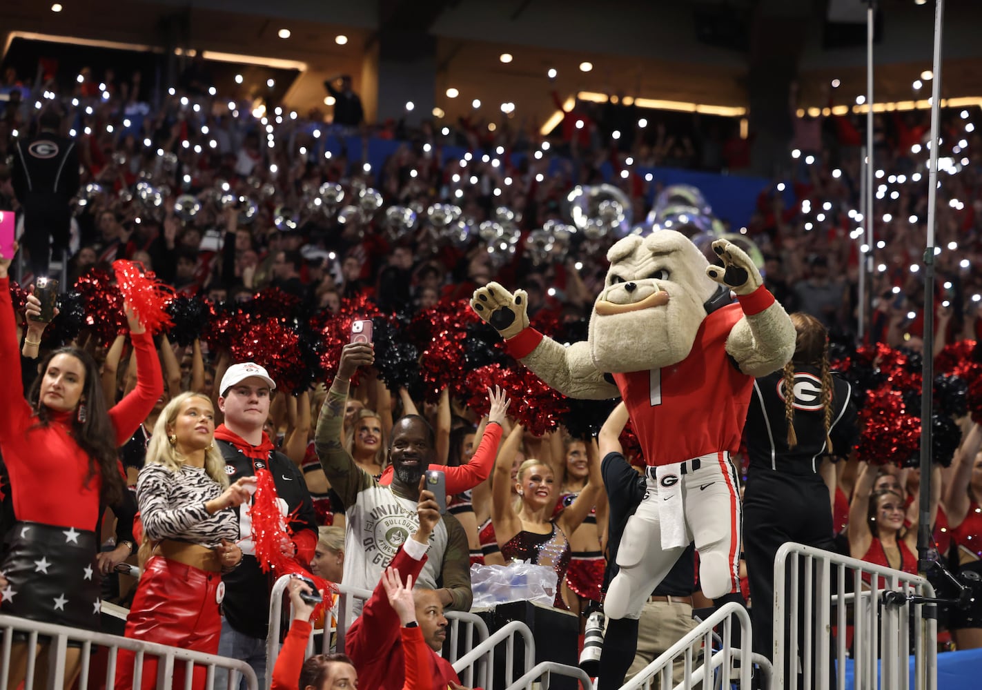 Georgia fans light up the stadium at the start of the fourth quarter of the College Football Playoff Semifinal between the Georgia Bulldogs and the Ohio State Buckeyes at the Chick-fil-A Peach Bowl In Atlanta on Saturday, Dec. 31, 2022.  Georgia won, 42-41. (Jason Getz / Jason.Getz@ajc.com)