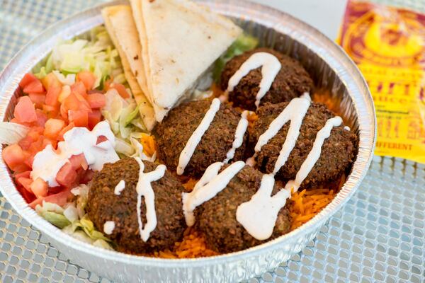  Falafel platter with rice, lettuce, tomato, grilled pita, and special white sauce. Photo credit- Mia Yakel.