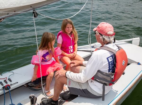 Eva Muhlhausen, 5, (from left) and her sister Ellen, 7, talk with their grandfather John on his Snipe sailboat at the the Atlanta Yacht Club on Lake Allatoona. PHIL SKINNER FOR THE ATLANTA JOURNAL-CONSTITUTION.
